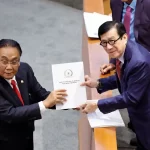 Yasonna Laoly, the Indonesian minister of law and human rights, receives the new criminal code report from Bambang Wuryanto, the head of the parliamentary commission overseeing the revision.