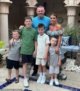 she posed with her four sons Kai, 13, Klay, nine, tackle, six and Cass, four, and hubby Wayne, 37, as they all slipped matching gleeful pyjamas