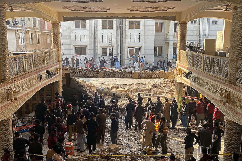 Security officials inspect the site of a mosque blast inside the police headquarters in Peshawar, Jan. 30, 2023.