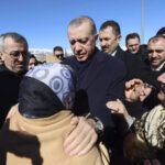 Erdogan with survivors during his visit to an earthquake-hit area