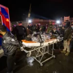 A migrant is rushed to the hospital after a fire broke out a Mexican immigration detention center in Juarez on Monday, March 27, 2023. A fire in a dormitory at a Mexican immigration detention center near the U.S. border left more than three dozen migrants dead. It was one of the deadliest incidents ever at an immigration lockup in the country. (Omar Ornelas /The El Paso Times via AP)
