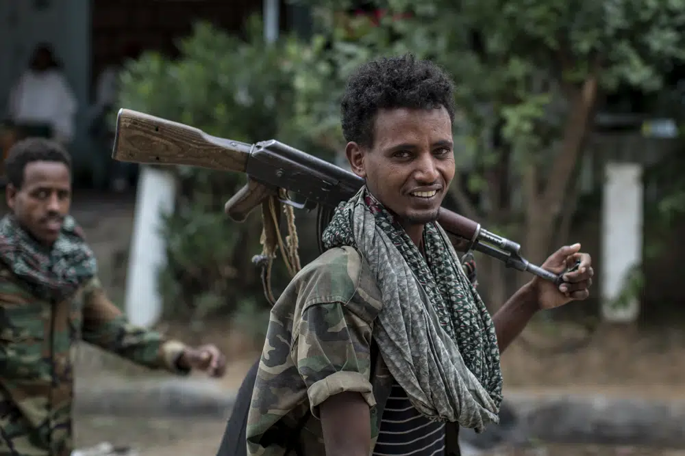 Fighters loyal to the Tigray People's Liberation Front (TPLF) walk along a street in the town of Hawzen, then controlled by the group, in the Tigray region of northern Ethiopia on May 7, 2021. Ethiopian lawmakers on Wednesday, March 22, 2023 have removed the TPLF from the country's list of designated terror groups more than four months after a peace agreement ended a conflict that killed hundreds of thousands of people.