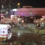 Image taken from a video showing ambulances and rescue teams staffers outside an immigration center in Ciudad Juarez, Mexico, Tuesday, March 28, 2023. At least three dozen migrants have died in a fire at an immigration detention center in northern Mexico near the U.S. border, according to a newspaper report. Images from the scene showed rows of bodies lying under shimmery silver sheets outside the facility in Ciudad Juarez, across from El Paso, Texas. Ambulances, firefighters and vans from the morgue could also be seen. (AP Photo)