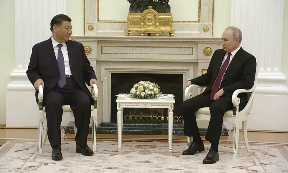 In this grab taken from video, China's President Xi Jinping, left, speaks with Russian President Vladimir Putin during their meeting in Moscow, Russia, Monday, March 20, 2023. (Russian Pool via AP)