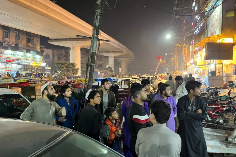 People come out of a restaurant after a tremor was felt in Lahore, Pakistan [Akhtar Soomro/Reuters]