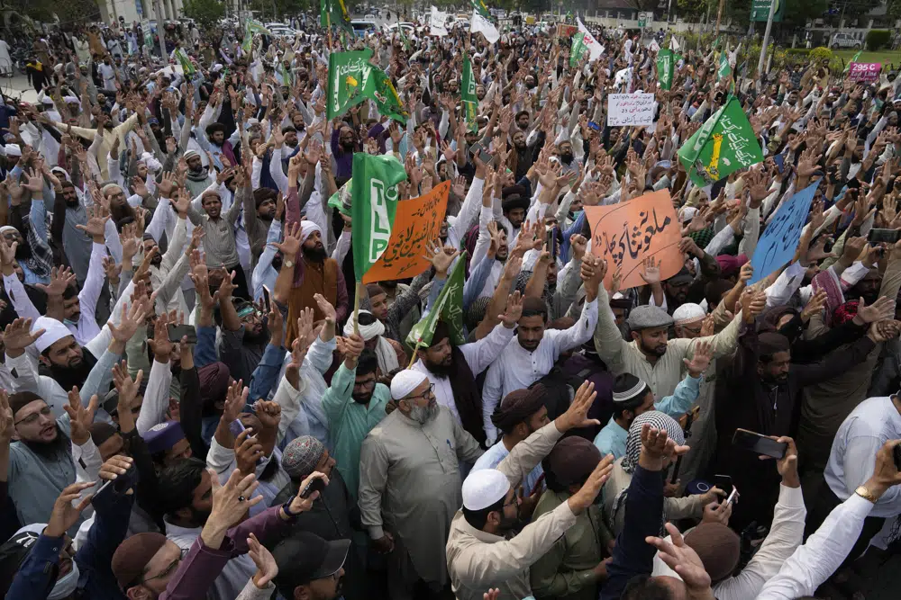 Supporters of a religious group 'Tehreek-e-Labiak Pakistan' chant slogans during a rally against a woman who recently arrested in the blasphemy charges, in Lahore, Pakistan, Monday, April 17, 2023. Pakistani police arrested a Muslim woman on charges of blasphemy after she allegedly claimed she was an Islamic prophet. She was taken into custody from her home in the eastern Punjab province after a mob had gathered outside demanding that she be lynched after news spread of her alleged claims of prophethood. (AP Photo/K.M. Chaudary)