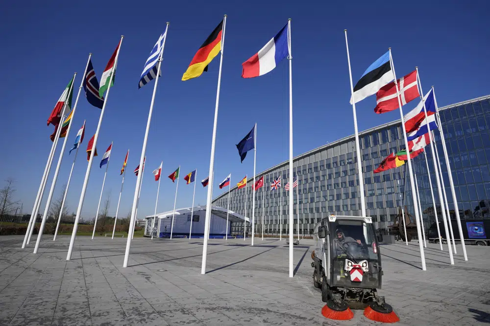 An empty flagpole stands between the national flags of France and Estonia outside NATO headquarters in Brussels, Monday, April 3, 2023. Finland awaits an official green light to become the 31st member of the world's biggest security alliance as NATO foreign ministers prepare to meet in Brussels on Tuesday and Wednesday. (AP Photo/Virginia Mayo)