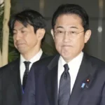 Japan's Prime Minister Fumio Kishida, right, meets reporters after an army helicopter went missing, at his official residence in Tokyo Thursday, April 6, 2023. Japan's coast guard says it is searching for an army helicopter carrying 10 crew members that went missing off a southern Japanese island. Kishida said the Defense Ministry is investigating and "We will do our utmost to save their lives." (Kyodo News via AP)