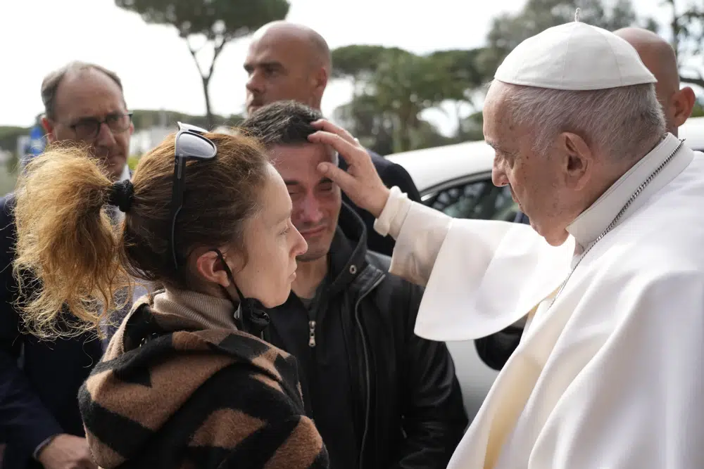 Pope Francis consoles Serena Subania and Matteo Rugghia who lost their daughter Angelica, 5 years old, the day before as he leaves the Agostino Gemelli University Hospital in Rome, Saturday, April 1, 2023 after receiving treatment for a bronchitis, The Vatican said. Francis was hospitalized on Wednesday after his public general audience in St. Peter's Square at The Vatican. (AP Photo/Gregorio Borgia)