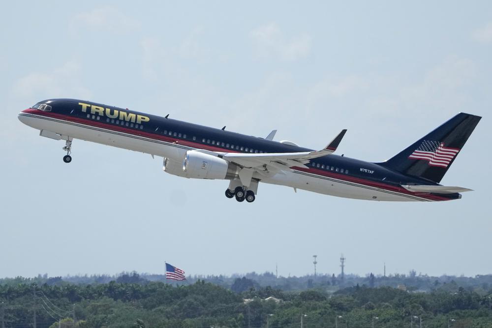 The plane carrying former president Donald Trump lifts off at Palm Beach International Airport, Monday, April 3, 2023, in West Palm Beach, Fla. Trump is heading to New York for his expected booking and arraignment on charges arising from hush money payments during his 2016 campaign.(AP Photo/Rebecca Blackwell)