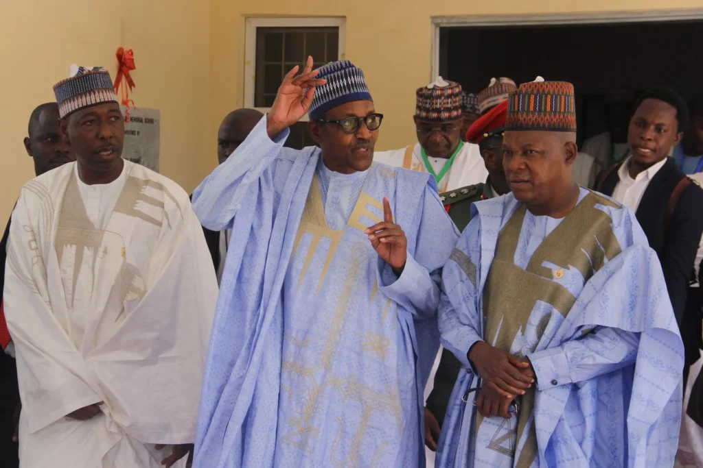 Nigeria President Muhammadu Buhari (middle), with current govenor of Borno State Babagana Zulum (L) and former governor Kashim Shettima (R) who is also vice president-elect. © Audu Ali MARTE / AFP/File