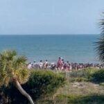 Beachgoers run from the site of a shooting in Isle of Palms, South Carolina. Jessica Gick via Storyfu