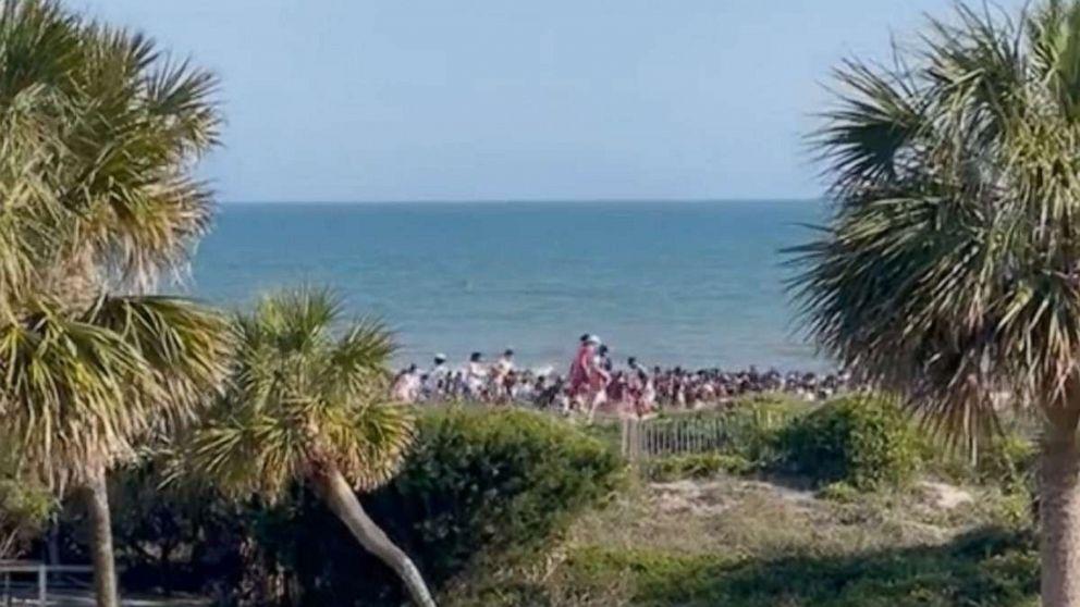 Beachgoers run from the site of a shooting in Isle of Palms, South Carolina. Jessica Gick via Storyfu
