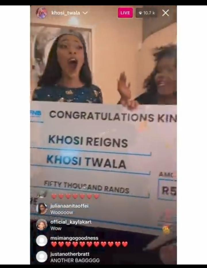 Khosi Twala holding the cheque of R50,000